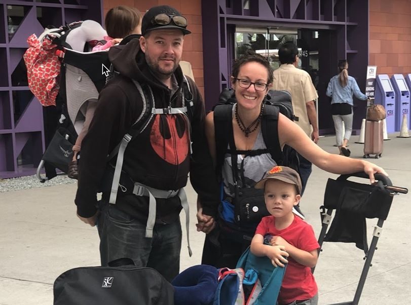 Wayne, Anna, and two kids at airport with luggage starting their lifestyle working nomads